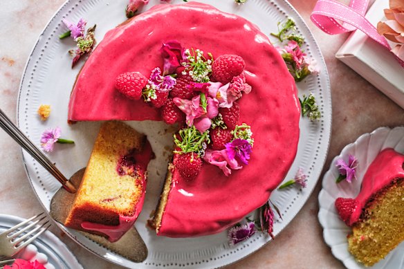 Decorate the cake with fresh raspberries and edible flowers.