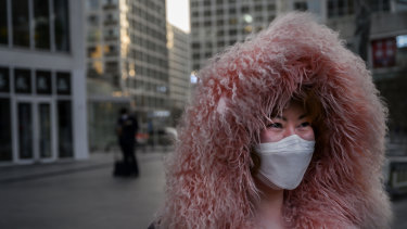 A woman leaves an office building in the central business district of Beijing.