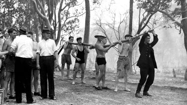 Locals and swimmers assist exhausted firemen in Sylvania in Sydney on January 14, 1939. At the time it was the hottest day on record in NSW.