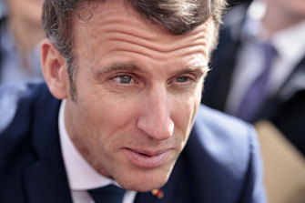 French President and centrist candidate for re-election Emmanuel Macron talks to residents as he campaigns in the village of Spezet, Brittany.