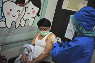 A volunteer receives a coronavirus vaccine during a trial at a community health centre in Bandung, West Java, Indonesia.