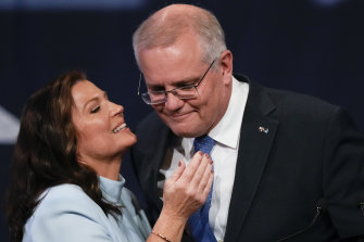 Outgoing Prime Minister Scott Morrison is embraced by his wife, Jenny, after conceding defeat.