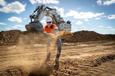 Adani Mining Australia chief executive David Boshoff ceremonially begins the removal of rock overburden at the Carmichael thermal coal  mine in Queensland's Galilee Basin.