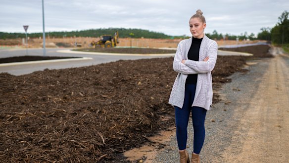 Emily Martin near a construction site which includes a block of land she and her partner purchased.