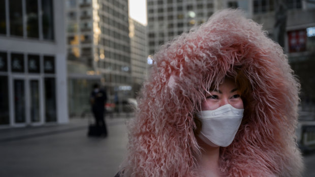 A woman leaves an office building in the central business district of Beijing.