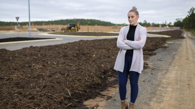 Emily Martin near a construction site which includes a block of land she and her partner purchased.