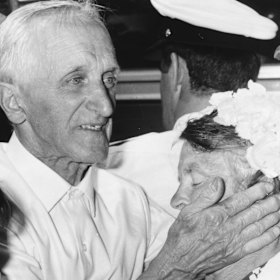 An elderly survivor comforts his shocked wife at the Spencer Street meeting point.