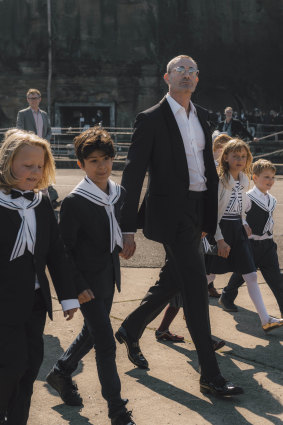 Peter Wilson arrives with his crew of sailor boys and girls at last Saturday's wedding on Cockatoo Island.