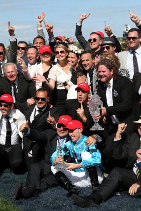 For the people: Jockey John Allen celebrates Extra Brut's Victoria Derby victory with connections on Saturday.
