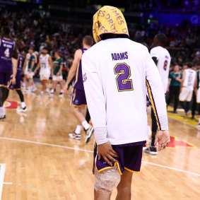 Jaylen Adams clutches his injured left hamstring after Sydney’s game one win.