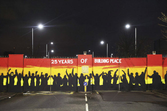 A mural on the peace gates at Lanark Way celebrates the Good Friday Agreement, in west Belfast, Northern Ireland.