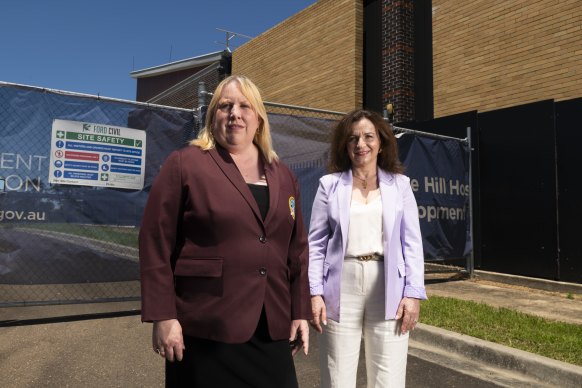 Mayor of Hill Shire Michelle Byrne (left) and resident Vicki Giannoulis at the Rouse Hill hospital site, which remains a green field almost a decade after it was first promised.