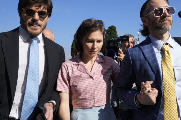 Amanda Knox arrives flanked by her husband Christopher Robinson (right) at the Florence courtroom this week.