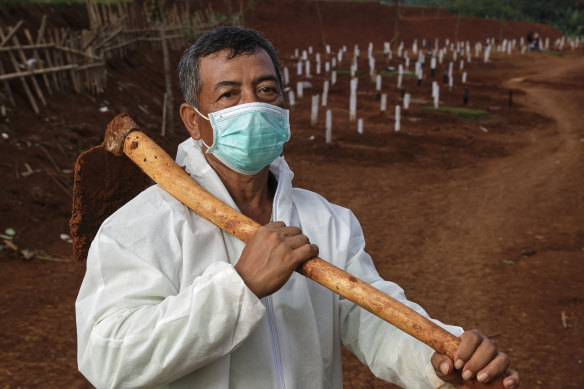 Pak Tuing, a grave digger at a public cemetery that is being expanded to accommodate rising COVID-19 deaths in Jakarta.