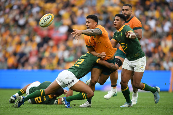 Len Ikitau of the Wallabies offloads.