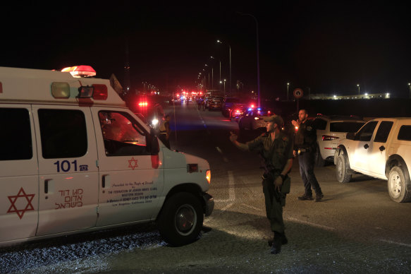 Emergency services personnel at the scene of the drone strike in Binyamina, Israel.