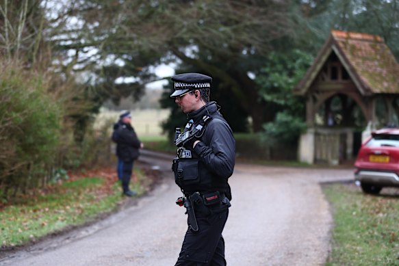 Police officers stand guard near the entrance to Wood Farm, the home of Andrew Mountbatten-Windsor.