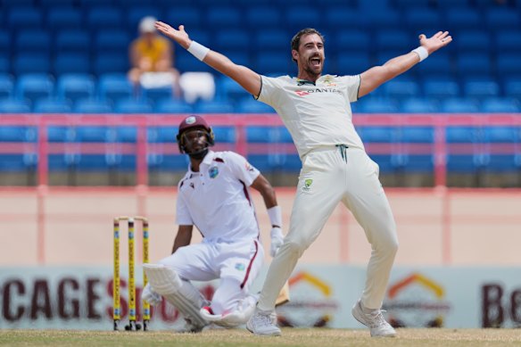 Australia’s Mitchell Starc celebrates taking the wicket of West Indies captain Roston Chase. 