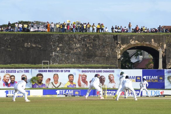 Protest signs were visible on the fort ramparts in Galle on day two of the Test match as Australia batted.