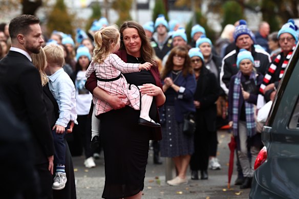 Bec Daniher shares a moment outside the service.