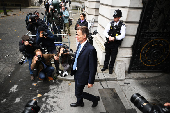 New Chancellor Jeremy Hunt walks from the Foreign & Commonwealth Office in London, England.