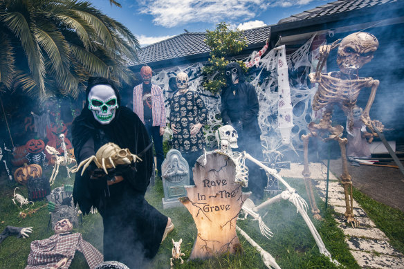  Dee Ken (in white and green mask) with Ayden, Keira and Zoe with their Halloween decorations at their Hoppers Crossing home.