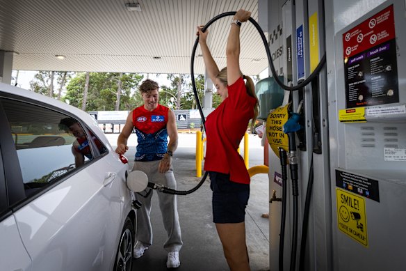 Brother and sister Jamie Roche and April Poutee find a novel way to extract the last drop of unleaded fuel from the hose.