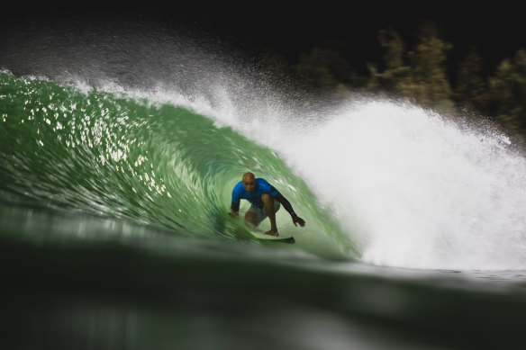 Kelly Slater tucks into a barrel at his own artificial wave pool in the Californian desert.
