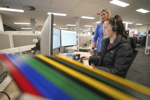  Monique Le-Vin takes calls, watched by Nicole Ashworth, acting executive director – emergency communication services, ESTA.