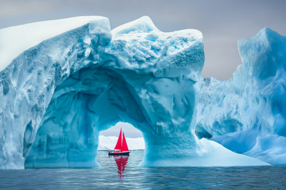 A boat saild past icebergs off Greenland.