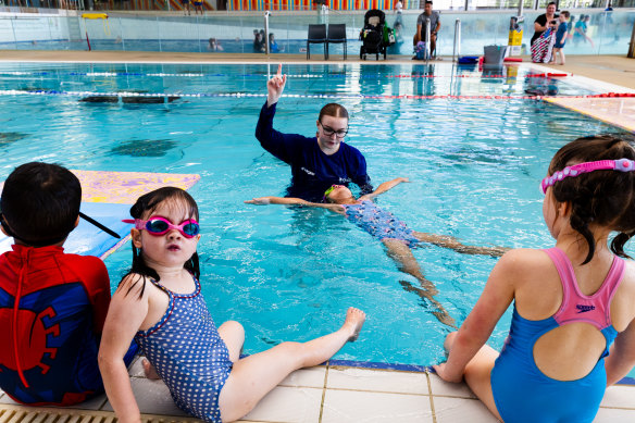 Survival skills: Georgia Breen (left), Elizabeth Alfar (floating), and Bronte Conroy with instructor Ellah Thornberry at Blacktown Leisure Centre Stanhope.