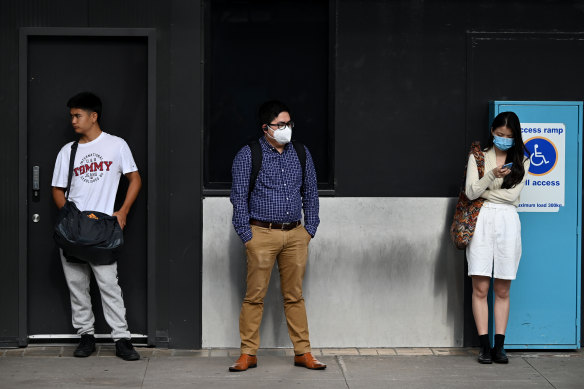 Train passengers wait on a Central Station platform during peak hour in Sydney.