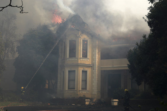 Firefighters work to douse a burning building at the University of Cape Town on Sunday.