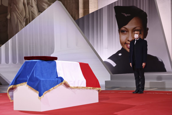 French President Emmanuel Macron pays respect to the cenotaph of Josephine Baker, covered with the French flag, at the Pantheon in Paris.