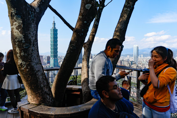 Hikers rest on top of Elephant Mountain in Taipei ahead of the Presidential election on Saturday. 