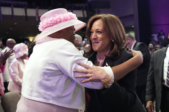 Kamala Harris and a churchgoer hug at a church in Stonecrest, Georgia on Sunday.