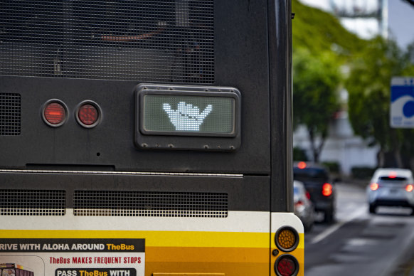 A Honolulu bus thanks drivers with a shaka after merging in Honolulu.