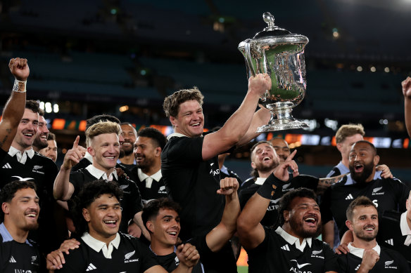 The All Blacks with the spoils of victory - again.