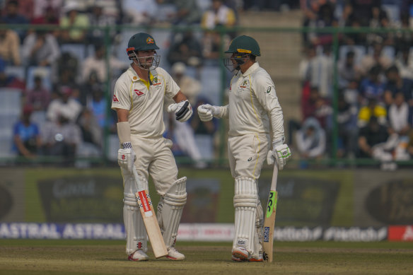 Australia’s Travis Head, left, and teammate Usman Khawaja talk.