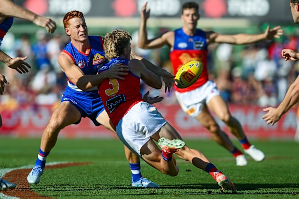 Jaspa Fletcher tries to burst his way through Bulldog Ed Richards.