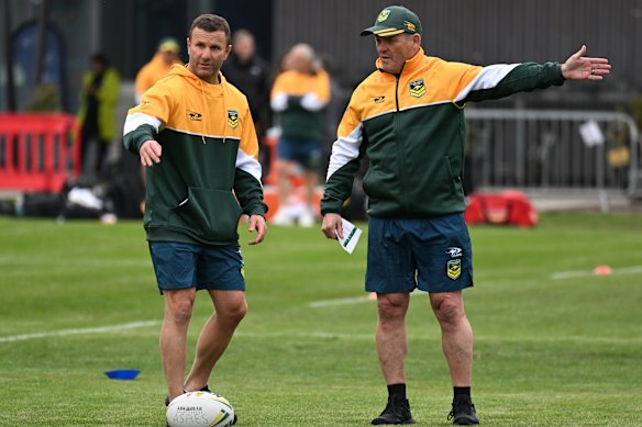 Assistant coach Willie Peters plans out training with head coach Kevin Walters.