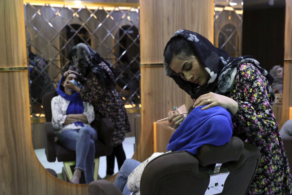 Sultana Karimi applies make-up at a beauty salon in Kabul. Some Afghan women fear the return of the Taliban and their hard-line stance on women’s rights.
