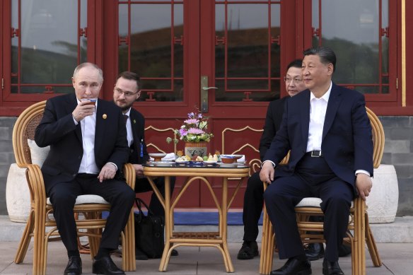 Russian President Vladimir Putin and Chinese President Xi Jinping attend an informal meeting in Beijing, China.
