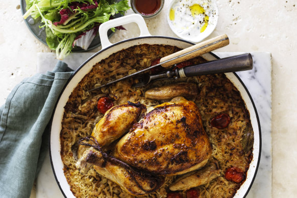 Roast chicken on baked rice with tomato, cumin and bay leaves.