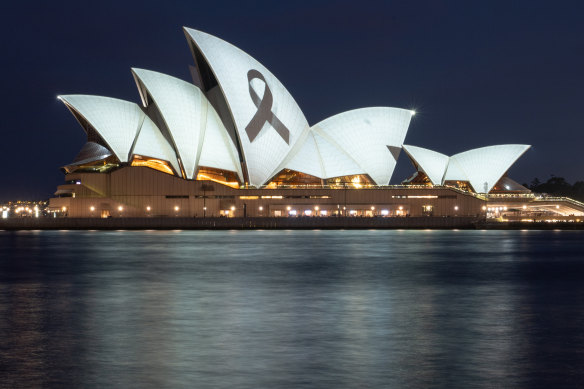A black ribbon is projected on the Sydney Opera House.
