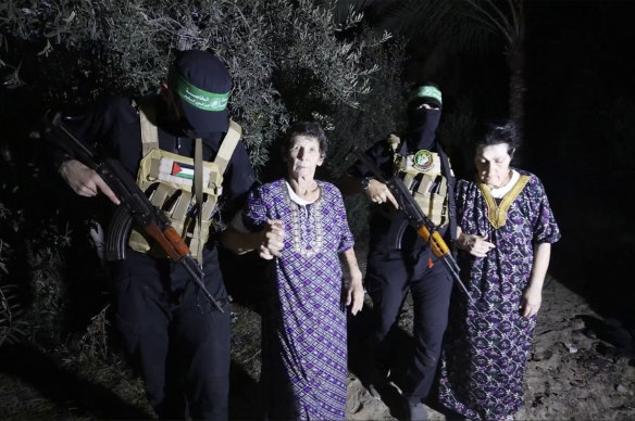 Hostages Yocheved Lifshitz, 85 (centre) and Nurit Cooper, 79, are released by Hamas.