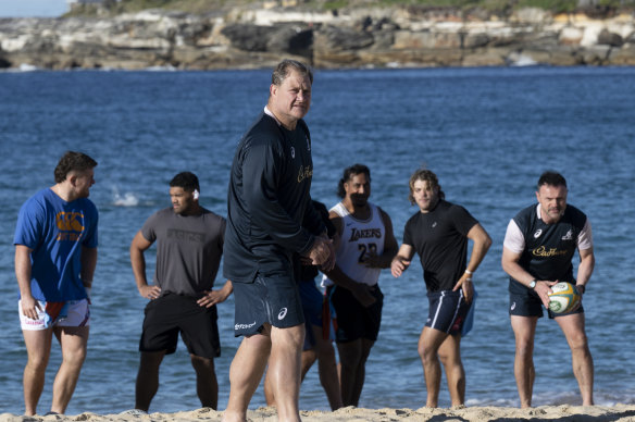 Neal Hatley sets up a drill as swimmers cross Coogee Beach in the background.
