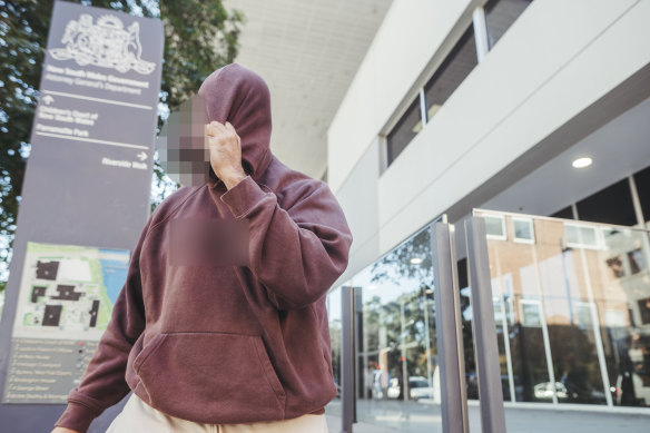 A supporter of the 14-year-old boy accused of possessing violent extremism material leaves Parramatta Children’s Court.