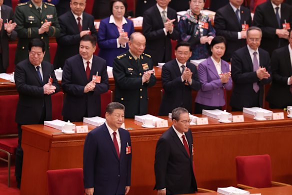 Chinese President Xi Jinping (front left) and Premier Li Qiang (right) arrive at the opening session of the National People’s Congress at the Great Hall of the People in Beijing on Thursday.