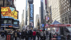 People wait in line to get tested for COVID-19 at a mobile testing site in Times Square. 